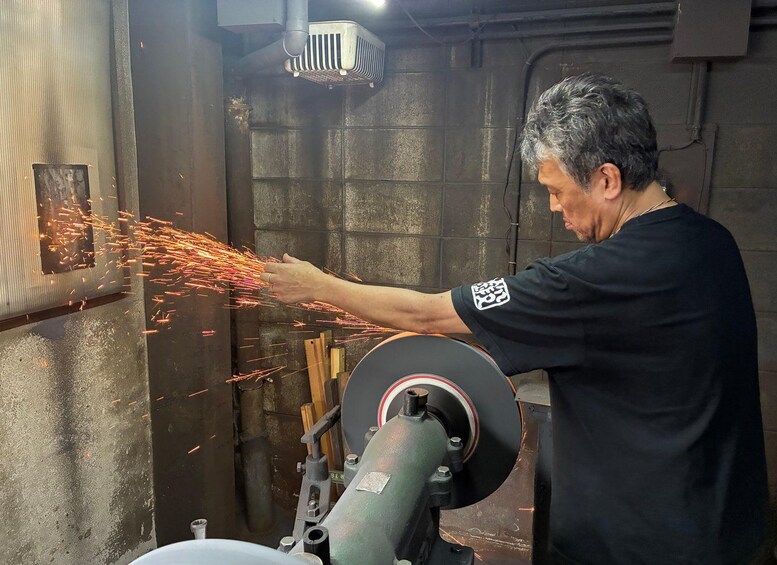 A person operating a machine with sparks flying, surrounded by industrial equipment. 1