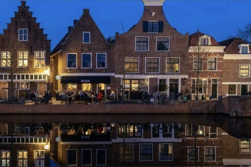 A canal-side building with a restaurant named 'De Koker' and a reflection in the water. 3