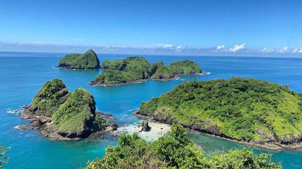 A group of lush green islands surrounded by clear blue waters. 2