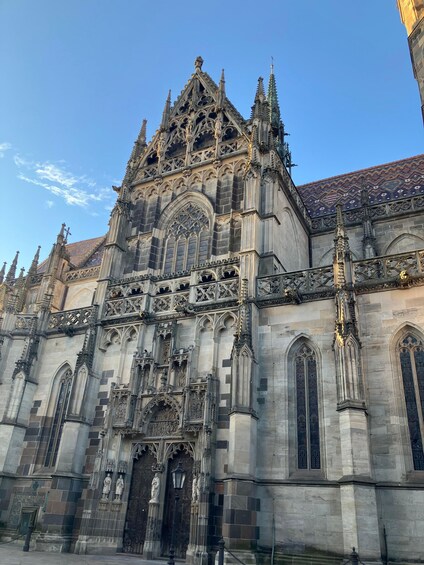 A Gothic-style cathedral with intricate stone carvings, pointed arches, and a steeply pitched roof. 4