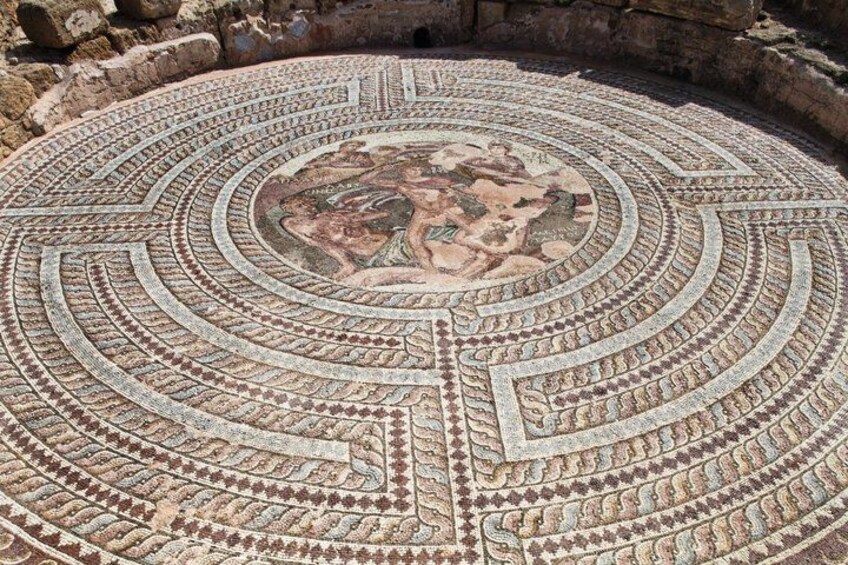 A circular mosaic with intricate patterns and a central depiction of a mythological scene. 5