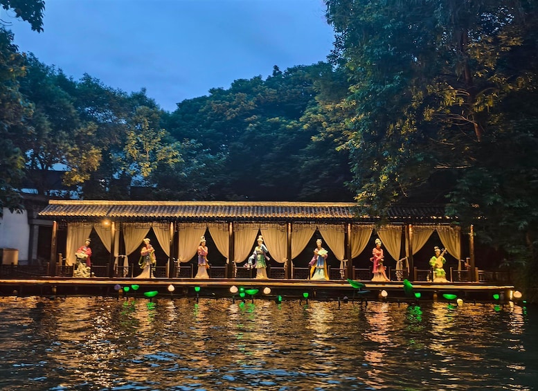 A traditional Chinese pavilion over a body of water, surrounded by trees. 2