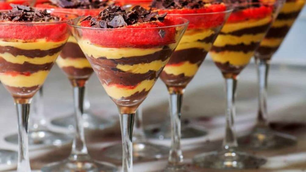 A dessert in a martini glass with multiple layers. 1