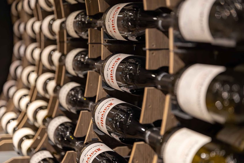 A wine rack with multiple bottles of wine. 1
