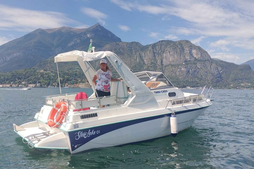 A boat named 'Stella Lake 01' on calm waters with a mountainous backdrop. 1