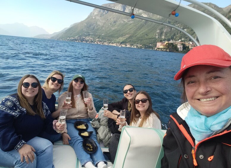 A group of people on a boat with a mountainous coastline in the background. 4