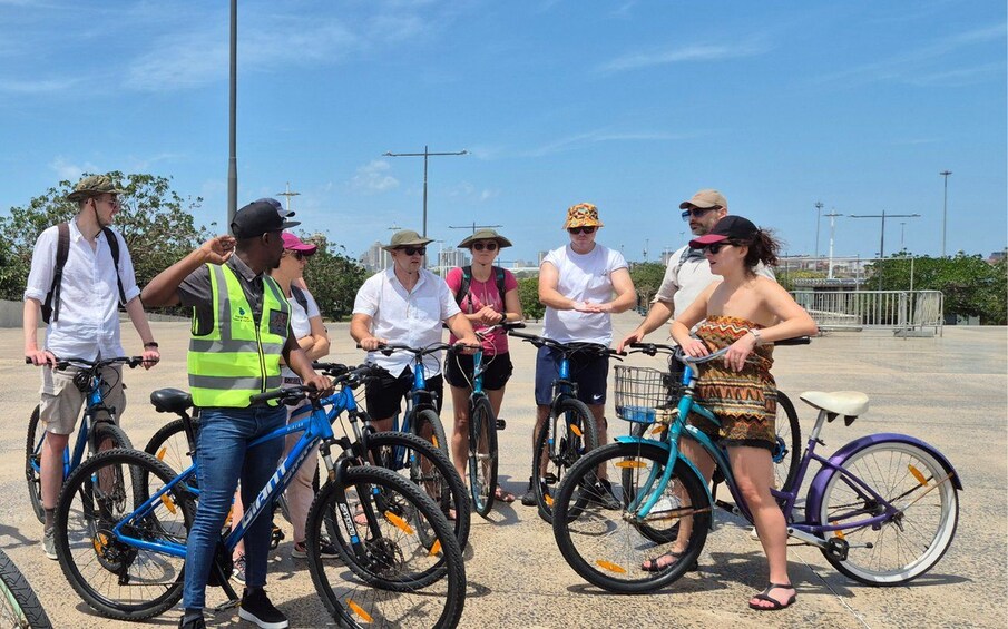 A group of people with bicycles in an outdoor setting. 3