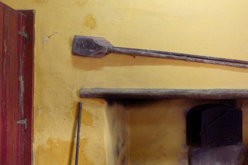 A wooden door, a metal latch, and a metal handle. 3