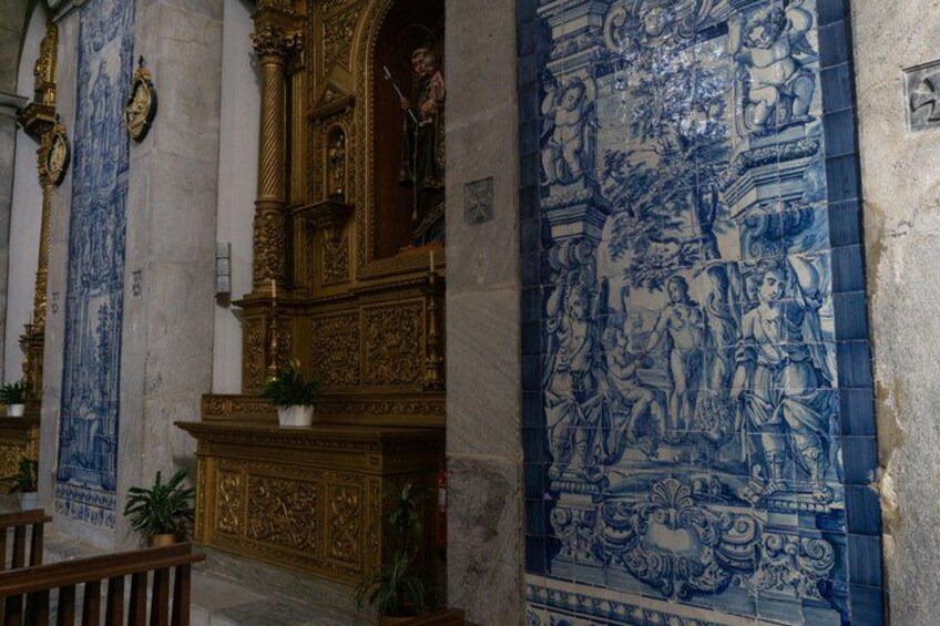 A church interior with ornate gold and blue tiles, a wooden pulpit, and a large mural. 4
