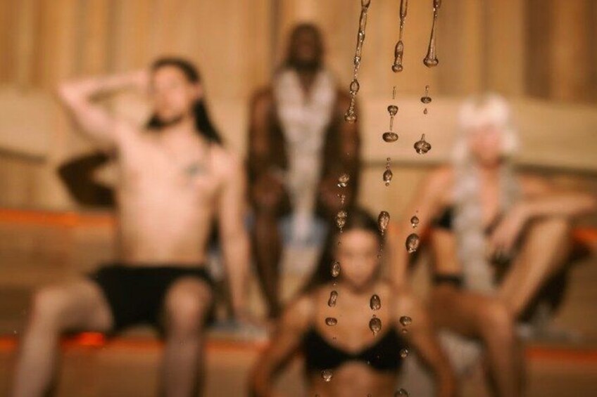 A group of people sitting on a couch with a blurred background. 2
