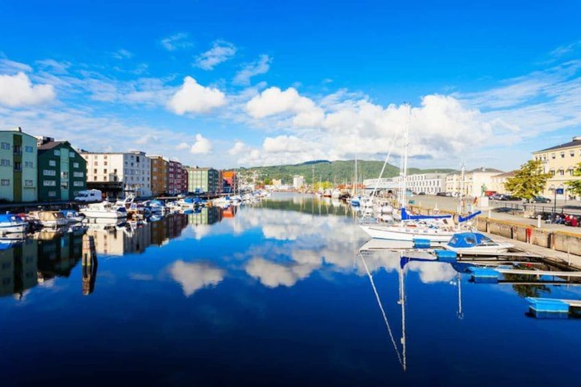 A harbor with boats, buildings, and a bridge. 3