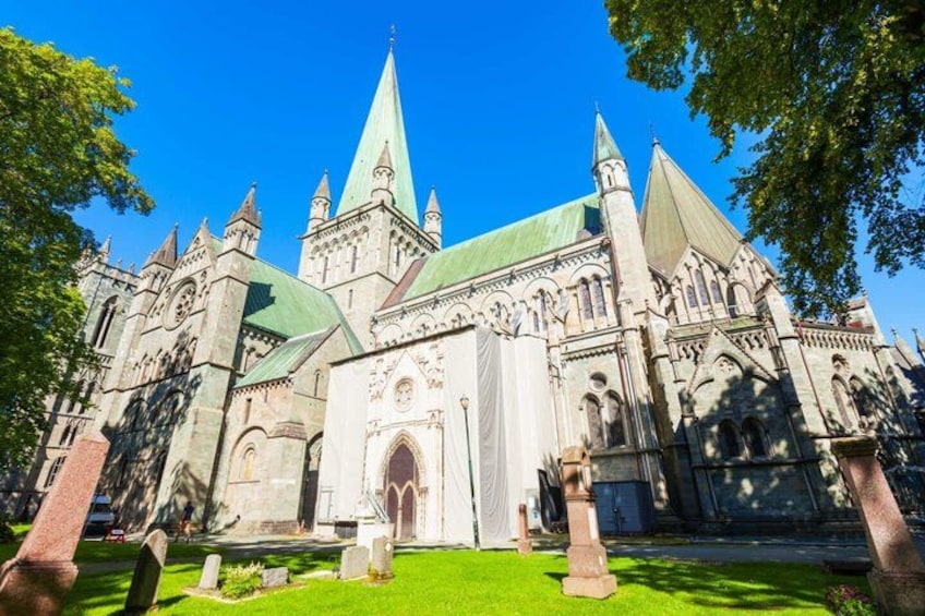 A historic church with a green roof and multiple spires. 4