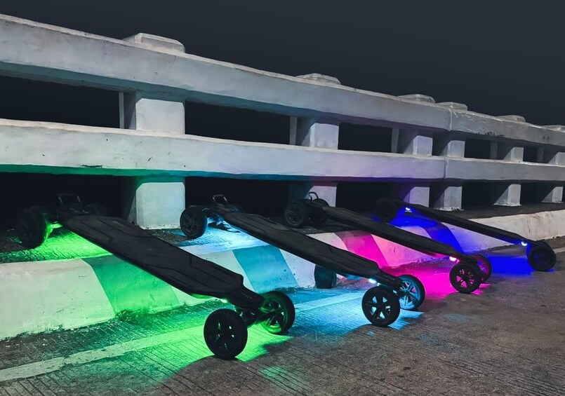 A series of colorful, illuminated ramps with wheels, likely part of an attraction or installation. 5