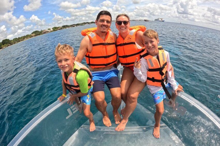 A group of people on a boat wearing life jackets. 3