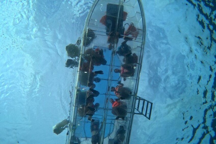 A transparent boat with people inside, surrounded by water. 4