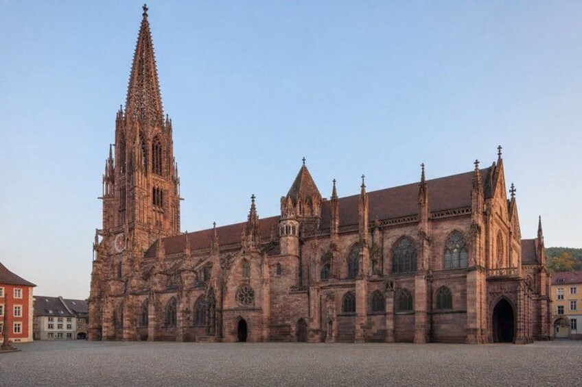 A large Gothic cathedral with a tall spire and multiple pointed arches. 1