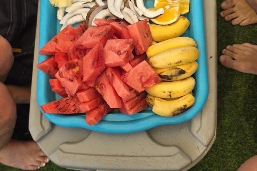A blue tray with sliced watermelon and bananas. 2