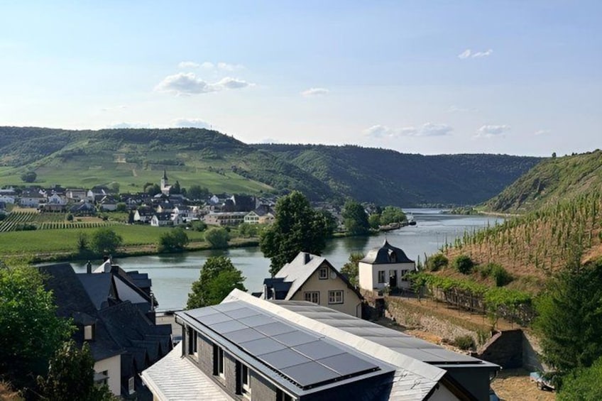 A river, houses, and hills. 2