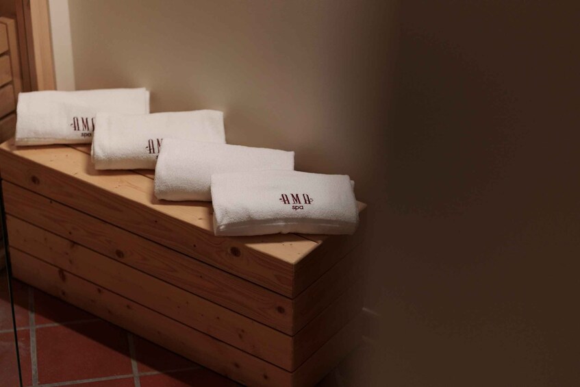 A wooden bench with towels on it. 3