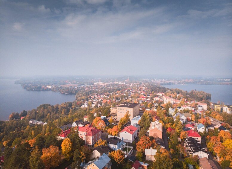 A town with colorful autumn foliage, a lake, and a distant island. 2