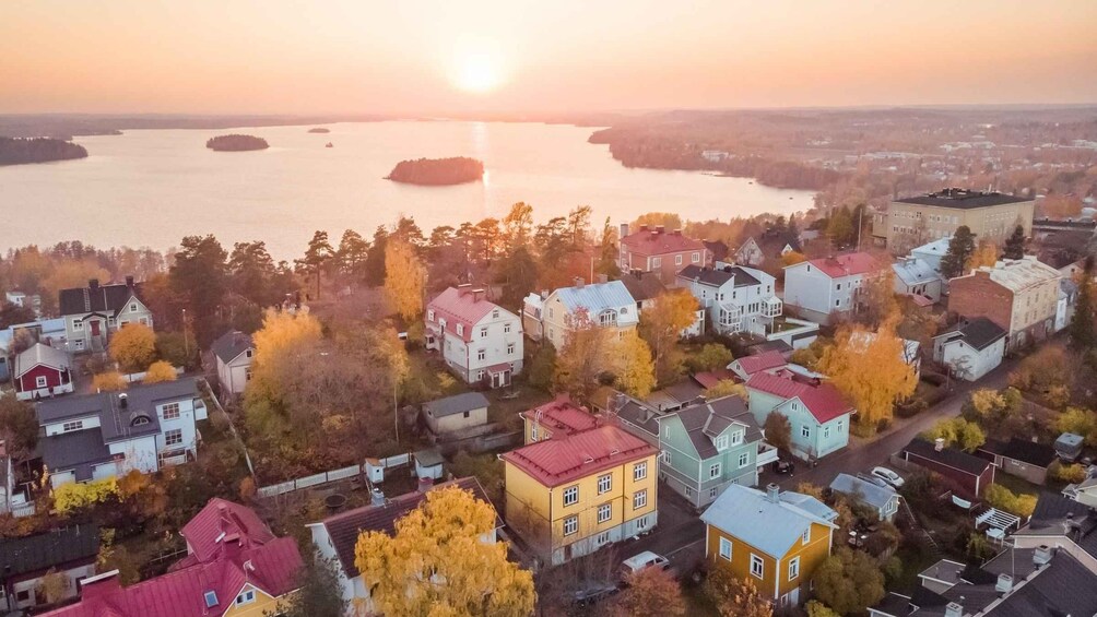 A coastal town at sunset with colorful houses and a calm sea. 1