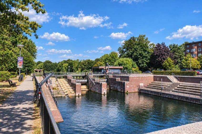 A canal with a lock system, a pathway, and a bridge. 3