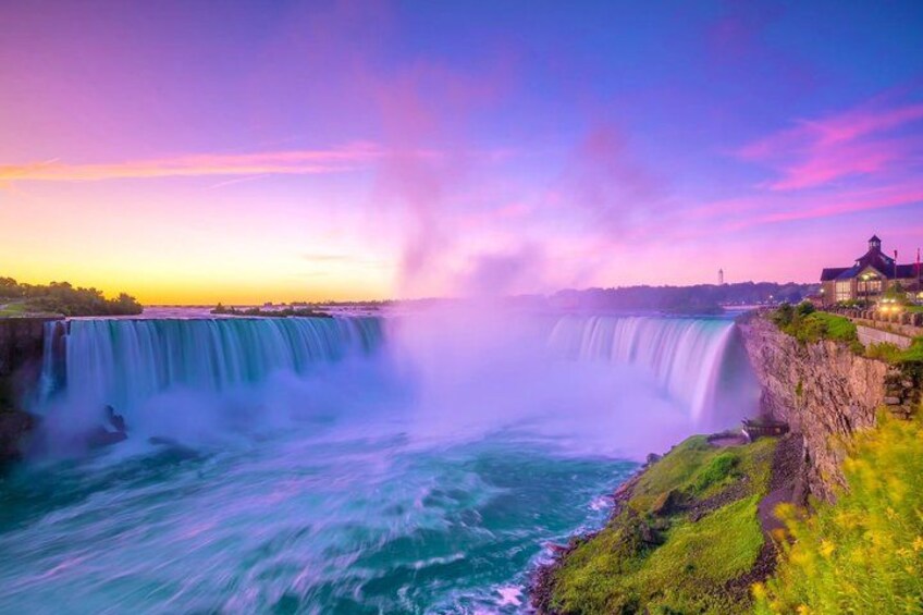 A waterfall, a cliff, and a building. 1