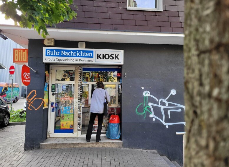 A kiosk named 'Ruhr Nachrichten' with a sign indicating it's the largest newspaper kiosk in Dortmund. 3