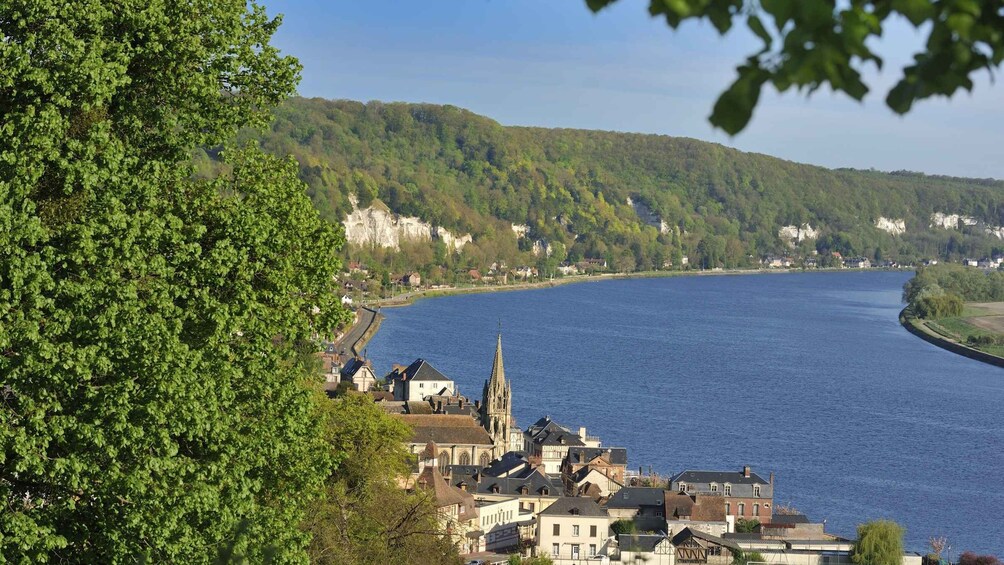 A river curving through a town with buildings and a church. 3
