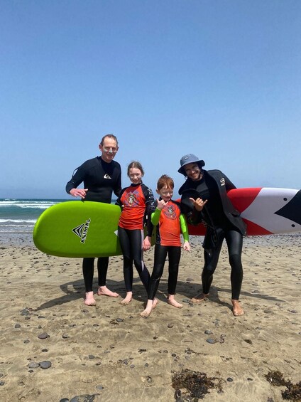 Un groupe de personnes sur une plage, tenant des planches de surf. 3
