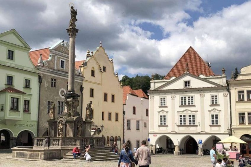 A historic square with a central fountain, surrounded by classical architecture and a clear sky. 3
