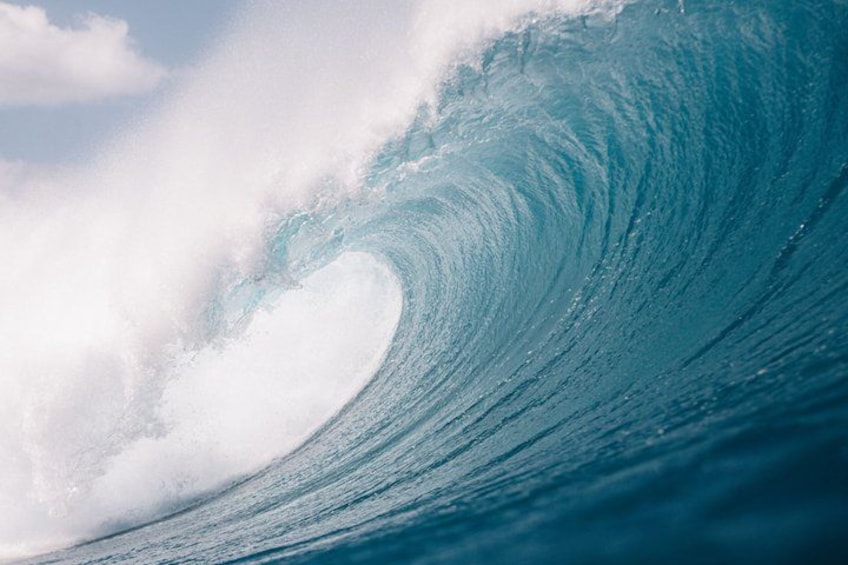 A large wave curling in the ocean. 2