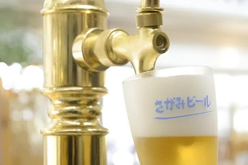 A brass tap with a glass of beer. 2