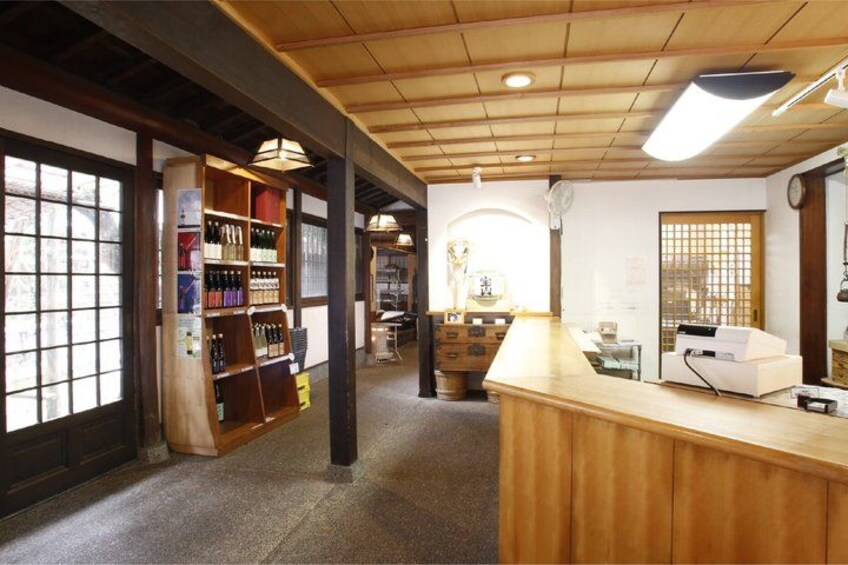 A traditional Japanese interior with wooden beams, tatami flooring, and a reception desk. 4