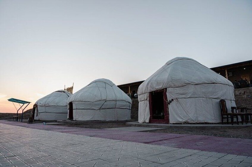 Three yurts with a paved walkway in front. 4