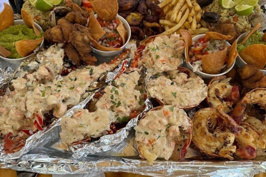 A variety of seafood dishes, including shrimp and lobster, served on a table. 4