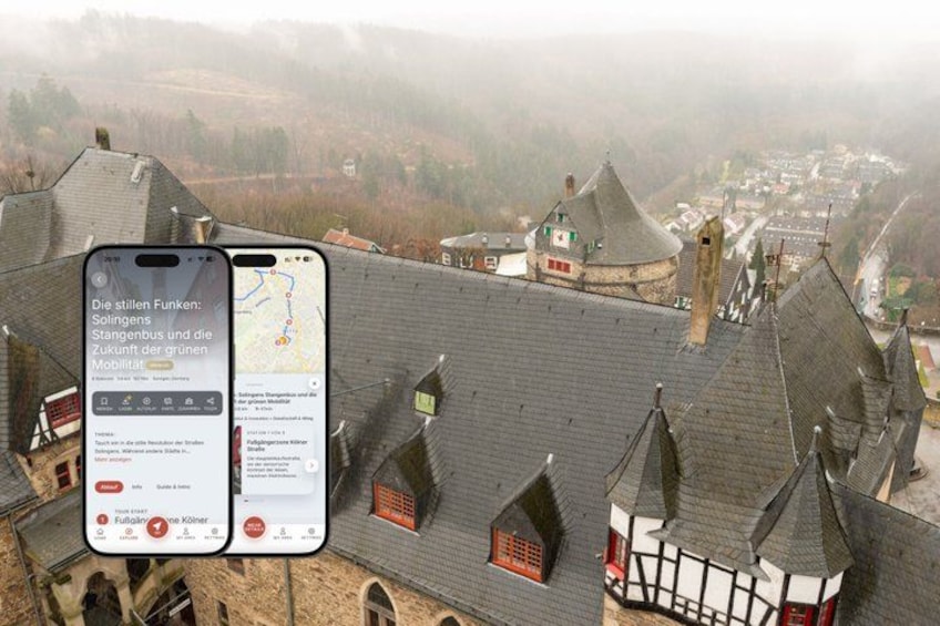 A smartphone displaying a map with text in German, a traditional building with steeply pitched roofs, and a misty landscape in the background. 1