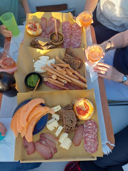 A charcuterie board with various meats, cheeses, and bread. 4