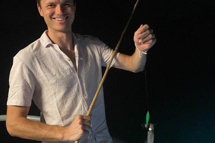 A person holding a fishing rod. 4