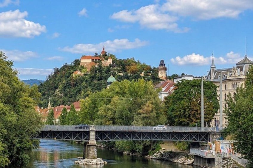 A river with a bridge, a hilltop castle, and a church. 4