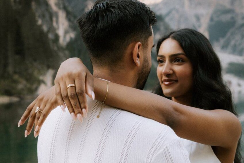 A couple embracing with a mountainous landscape in the background. 2