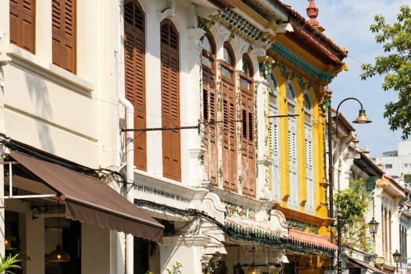 A traditional building with ornate architecture, including a tiled roof and decorative columns. 5