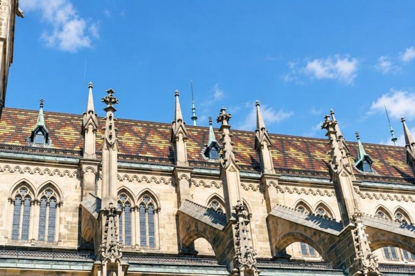 A historic building with ornate Gothic architecture, including pointed arches and intricate stone carvings. 4