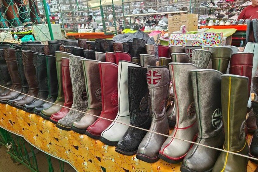 A row of boots on display at a market stall. 5