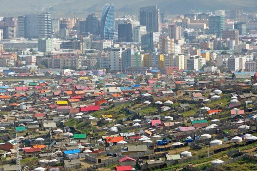 A cityscape with a mix of colorful residential buildings and modern skyscrapers. 1