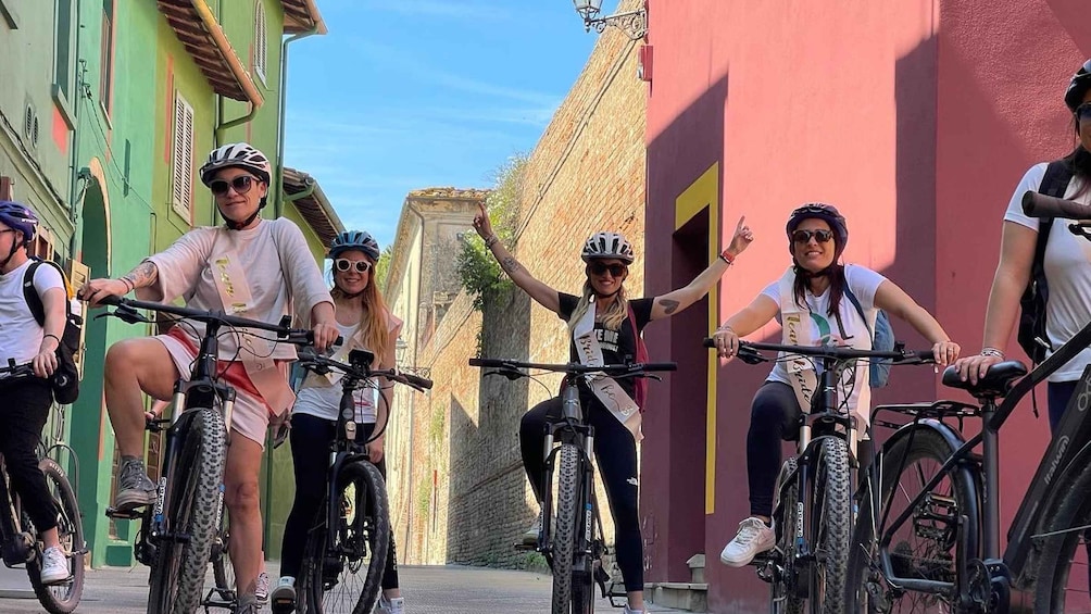 A group of cyclists on a street with colorful buildings. 5