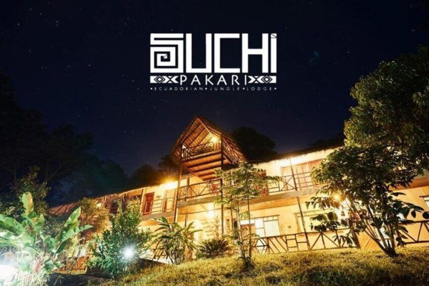 A well-lit lodge with a wooden structure and surrounding vegetation. 1