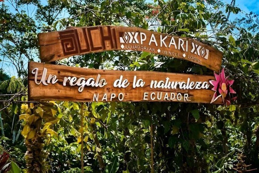 A wooden sign with text and a flower decoration. 4