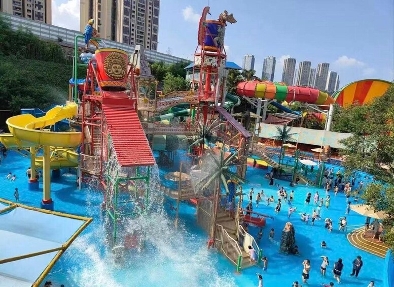 A water park with slides, a wave pool, and a red water slide. 2