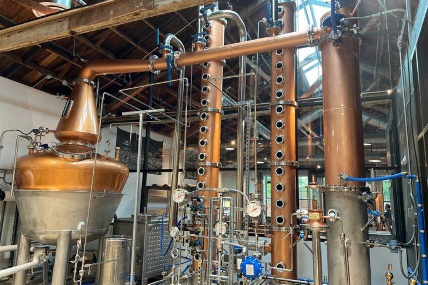 A distillery with copper stills and complex piping. 1